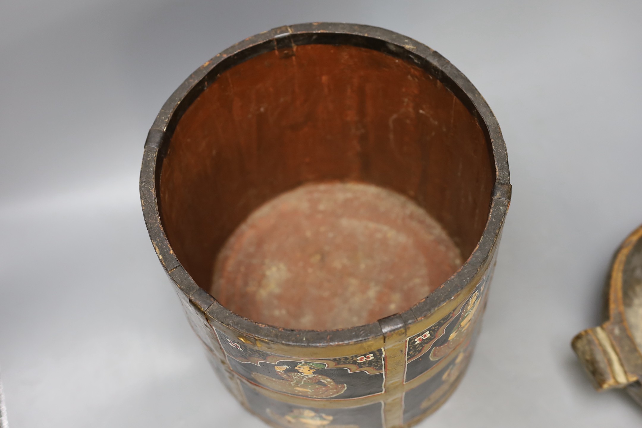 An African carved wood bowl, a Tibetan prayer wheel and a Persian waste basket